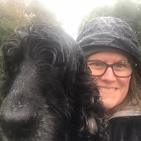 Llyn holding a small terrier with care